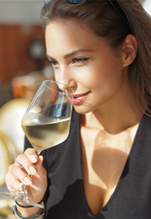 Woman enjoying a glass of Chardonnay wine